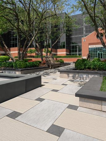 Techo-Bloc's commercial Ocean Grande patio slab and Valet paver installed in a basketweave pattern for an office outdoor landscape.