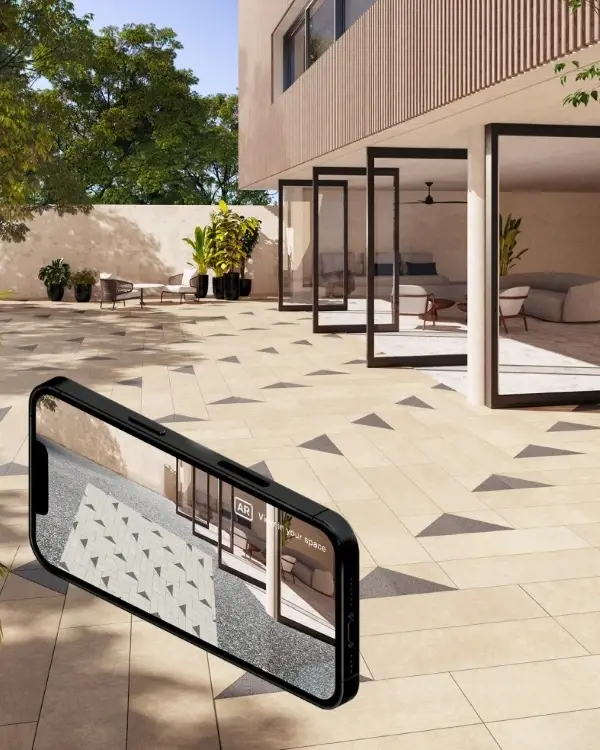 Smartphone showing Techo-Bloc augmented reality patio paver preview in modern outdoor setting.
