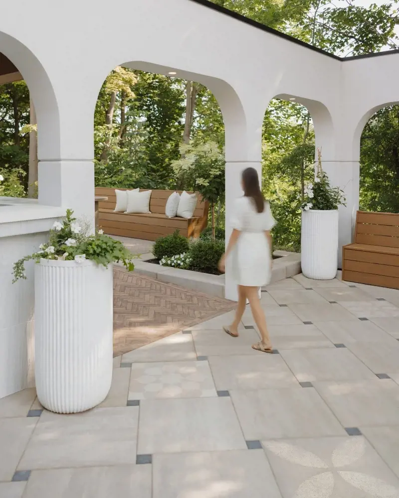 Minimalist patio designed with large-format light stone slabs, subtle inlay details, and clean architectural lines.