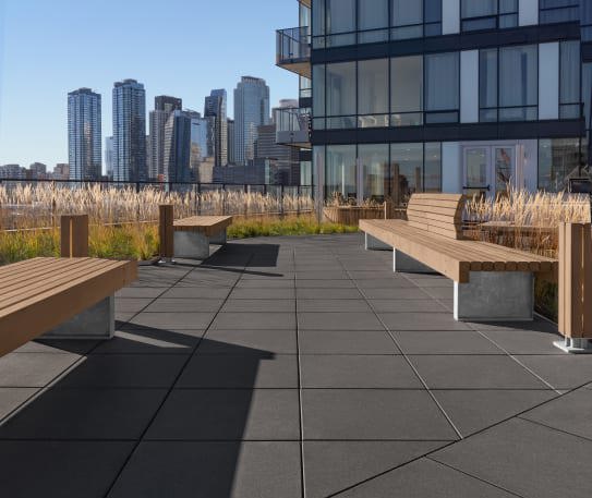 Techo-Bloc's sleek commercial Industria paver installed on the rooftop courtyard of Le Duke Condos in Montreal.