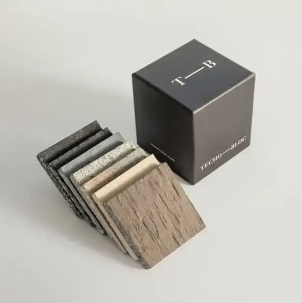Set of Techo-Bloc material samples displayed beside a branded sample box.