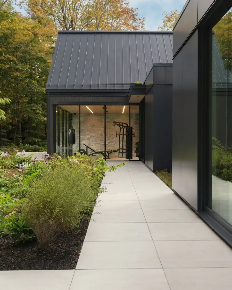 Modern outdoor walkway leading to a serene retreat space, designed with clean lines, soft tones, and a calm, minimalist atmosphere.