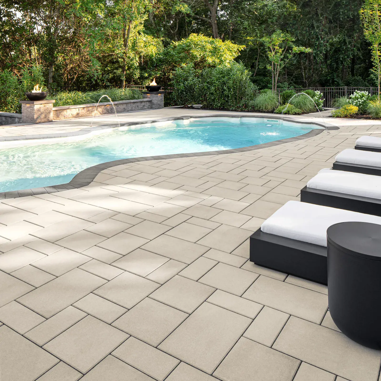 Blu 60 Smooth slab in Beige Cream surrounding a curved pool with dark border pavers