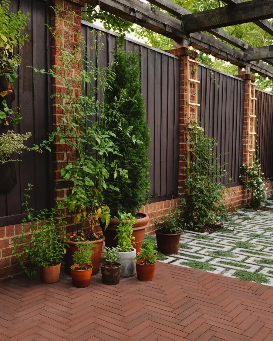 Garden pathway built with permeable Westmount pavers in Merlot, where planted openings soften the hardscape and enhance water absorption.