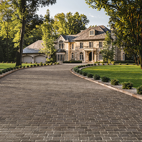 Oxford Pavers in a tight cobblestone pattern with earthy tones, creating a sophisticated, permeable driveway with excellent stain resistance.
