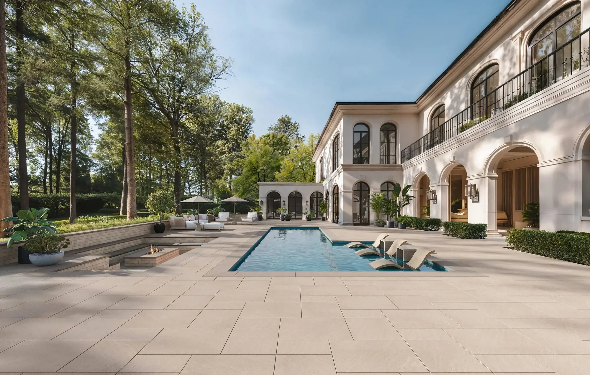 Luxury backyard with modern pool, lush landscaping, and premium Techo-Bloc pavers creating an elegant outdoor living space.