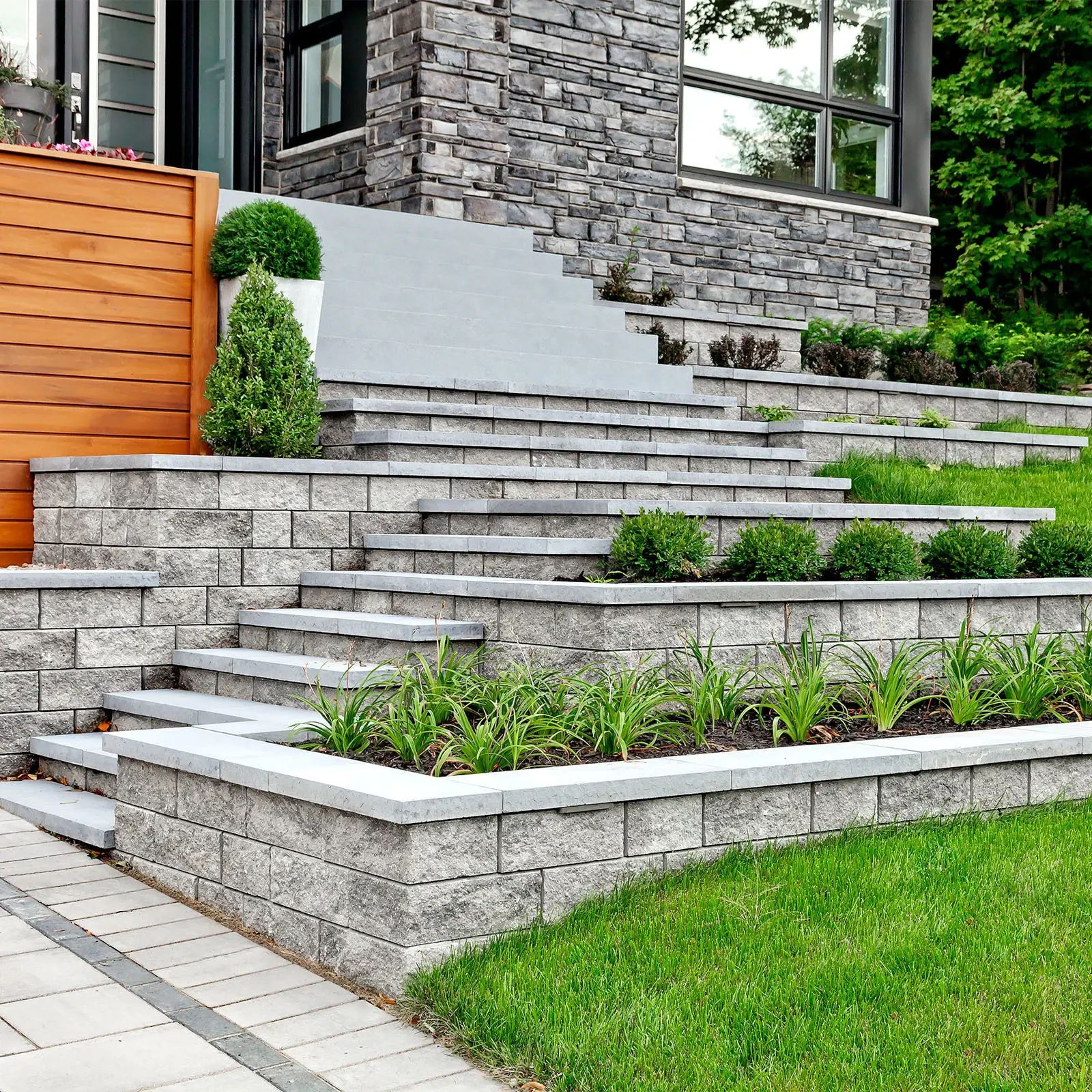 Semma Wall in Champlain Grey with tiered retaining walls and integrated steps
