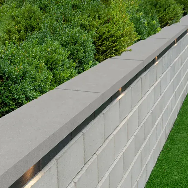 Sandstone Cap by Techo-Bloc, sleek concrete wall cap in Beige or Grey, providing a refined finish to walls and steps in the Natural Stone collection.