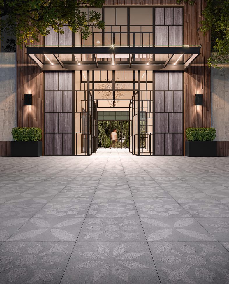 Entrée d'un espace commercial mettant en vedette les dalles commerciales Industria Flora de Techo-Bloc dans la couleur nickel grisé.