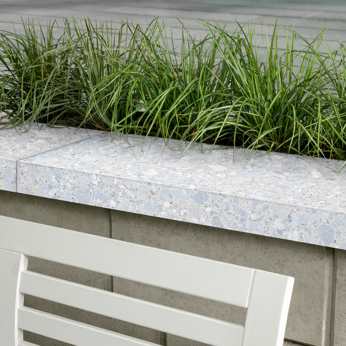 Terrazzo Cap in Stardust Beige with a polished speckled finish, shown on a poolside patio
