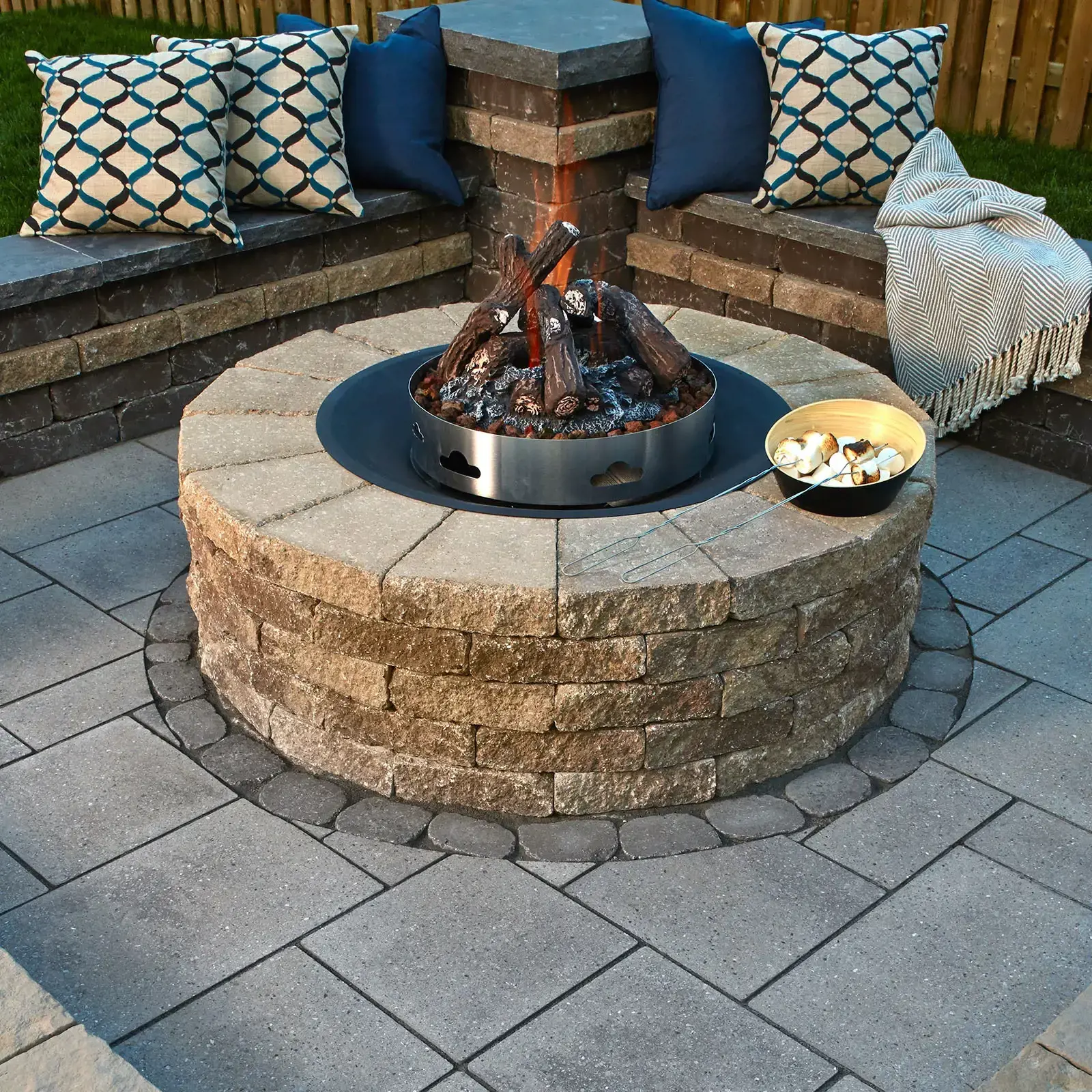Valencia Fire Pit in Chestnut Brown on a patio, showing the circular layout and stone texture