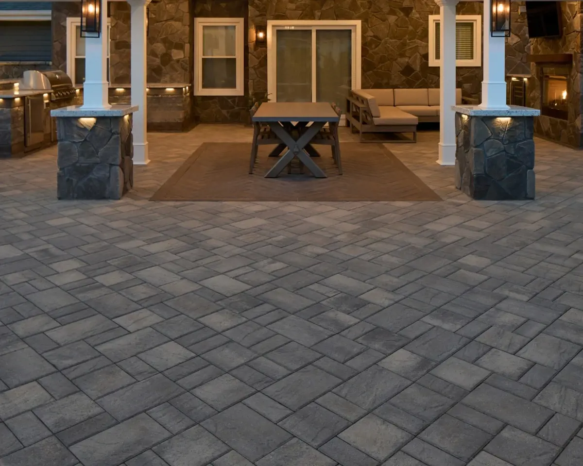 Eva Slate paver by Techo-Bloc in Champlain Grey with slate texture, used in a large patio under a covered outdoor seating area.