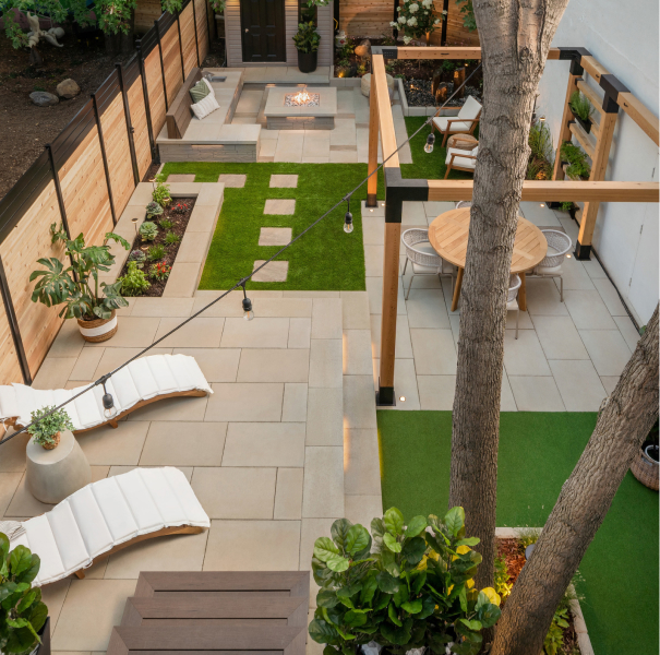 Modern rear terrace with large concrete slabs, comfortable seating area and dining area.