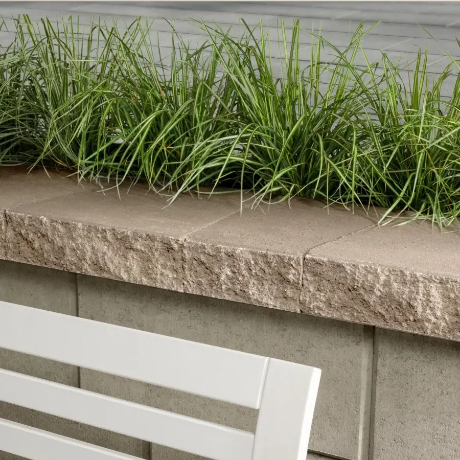 Couronnements Architectural par Techo-Bloc en Caffè Crema, vu de côté sur muret paysager moderne.