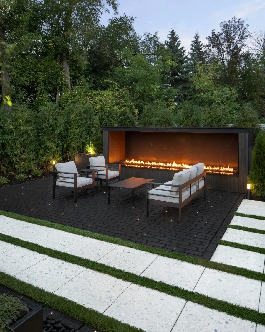 Residential courtyard surfaced with Terrazzo slabs in Mineral White, where light-toned textures create contrast with surrounding greenery.