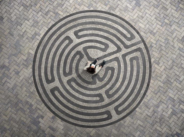 Aerial view of an intricate circular pattern created by using dark grey pavers.