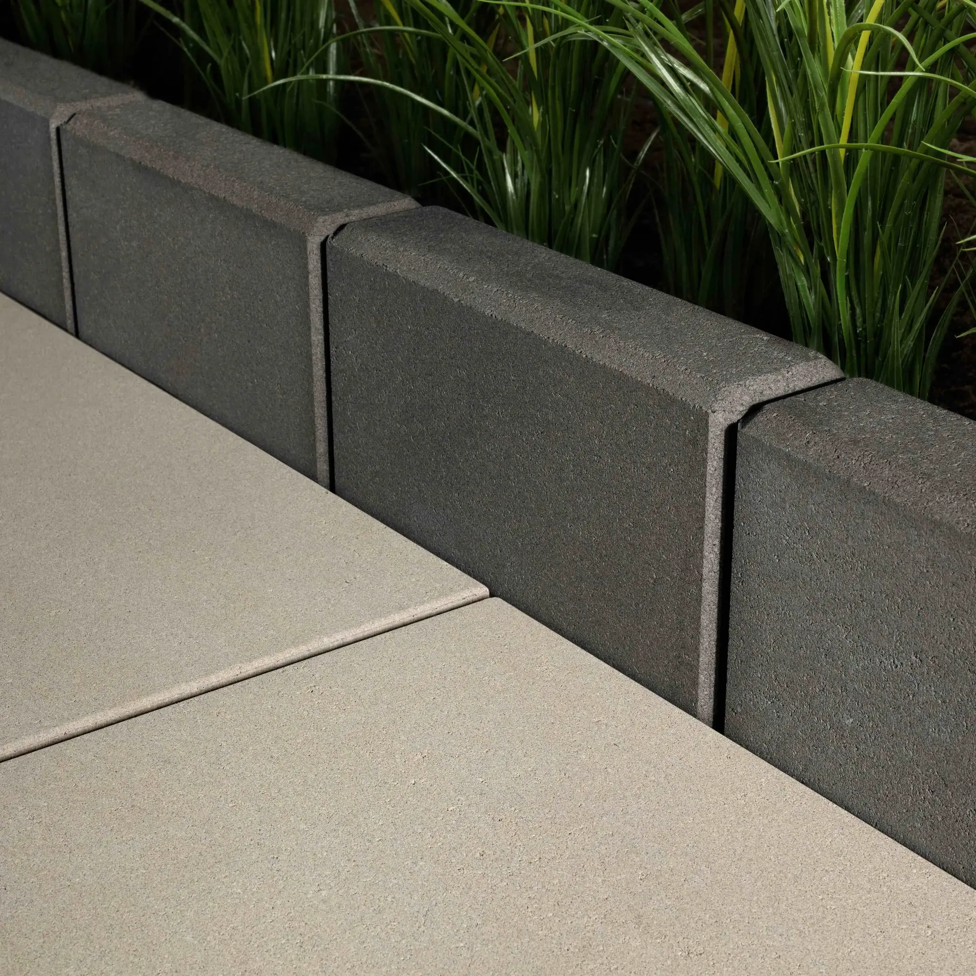 Raffinato Smooth edging stone in Beige Cream, shown on a raised planter wall with white coping