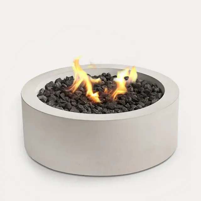 Sculptura Fire Pit Circle by Techo-Bloc, circular fire pit with lava rock, creating a stylish and cozy outdoor feature with a sleek modern design.