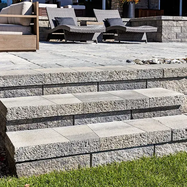 Architectural by Techo-Bloc, rustic double-sided concrete wall cap and step tread, adding a sturdy and textured finish to outdoor steps and walls.