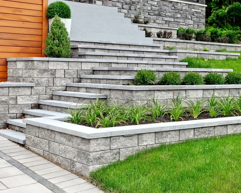Semma Wall retaining walls, steps, and raised planters in a modern backyard landscape 