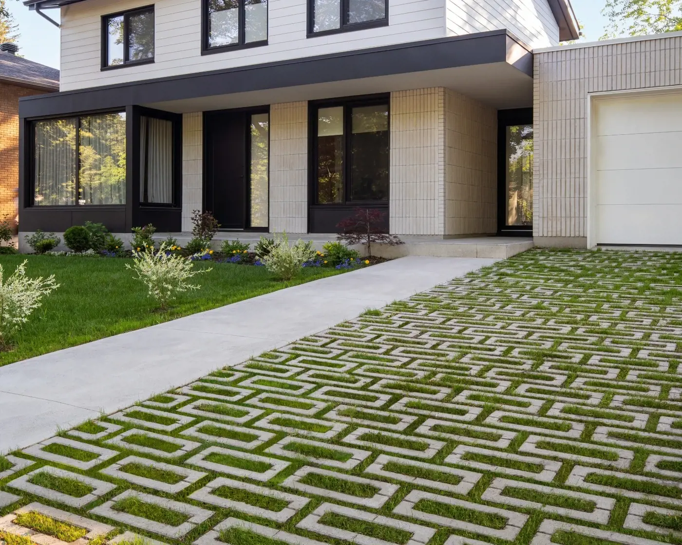 Outdoor terrace with a pool, wide steps, and a modern lounge area styled with light grey slabs and steps from the Techo-Bloc Terrazzo Collection.
