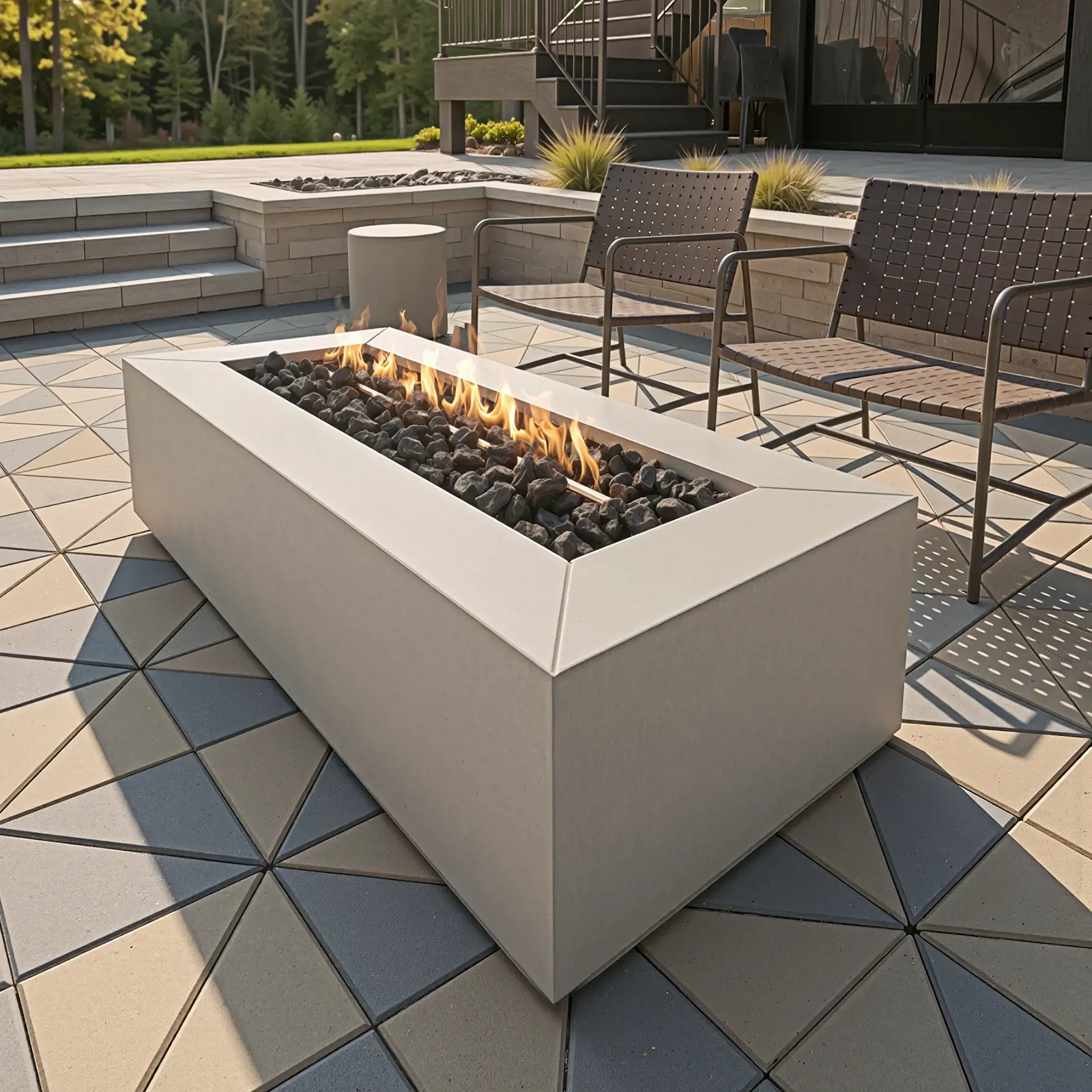 Sculptura Rectangle Firepit in Cool Grey on a patio with geometric paving stones