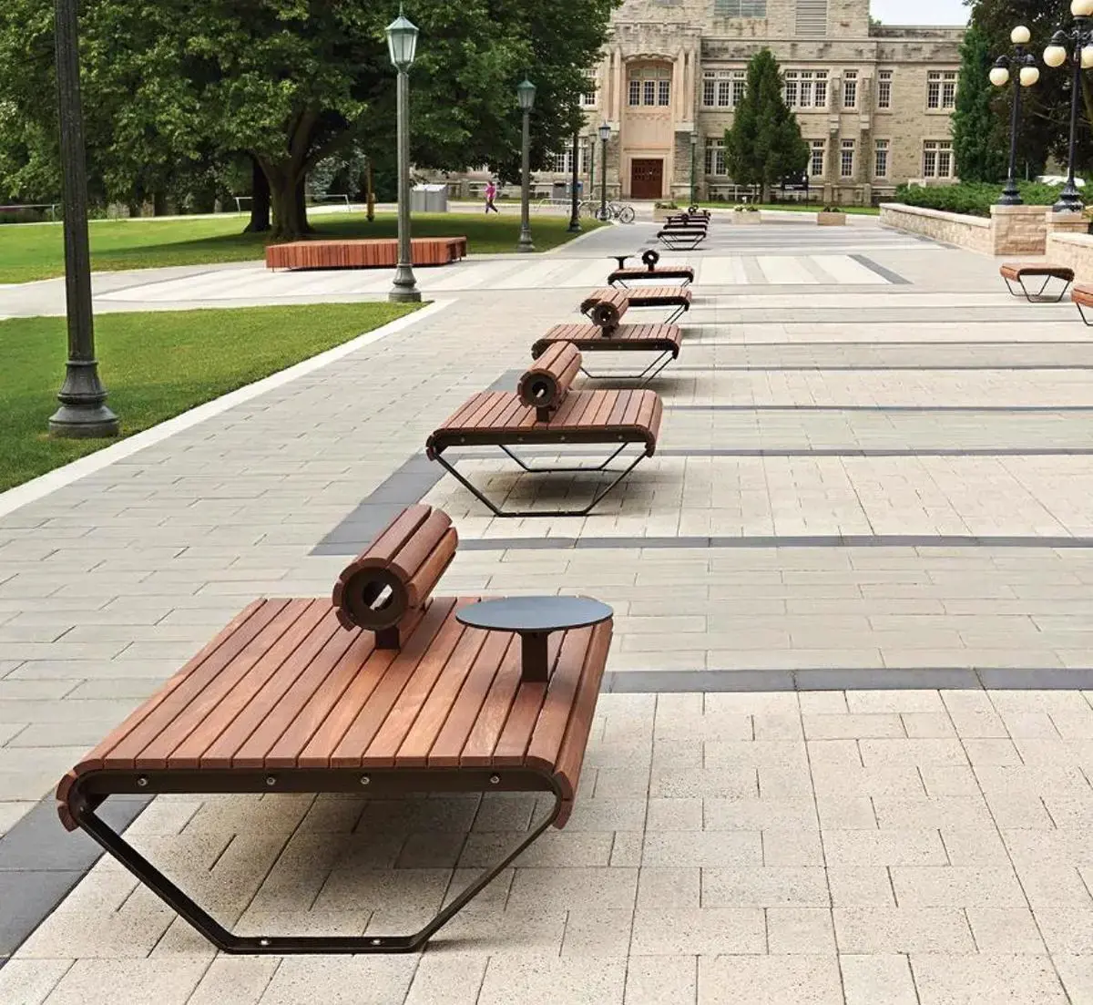Public plaza featuring Techo-Bloc pavers in coordinating tones, with benches arranged along a wide pedestrian pathway.