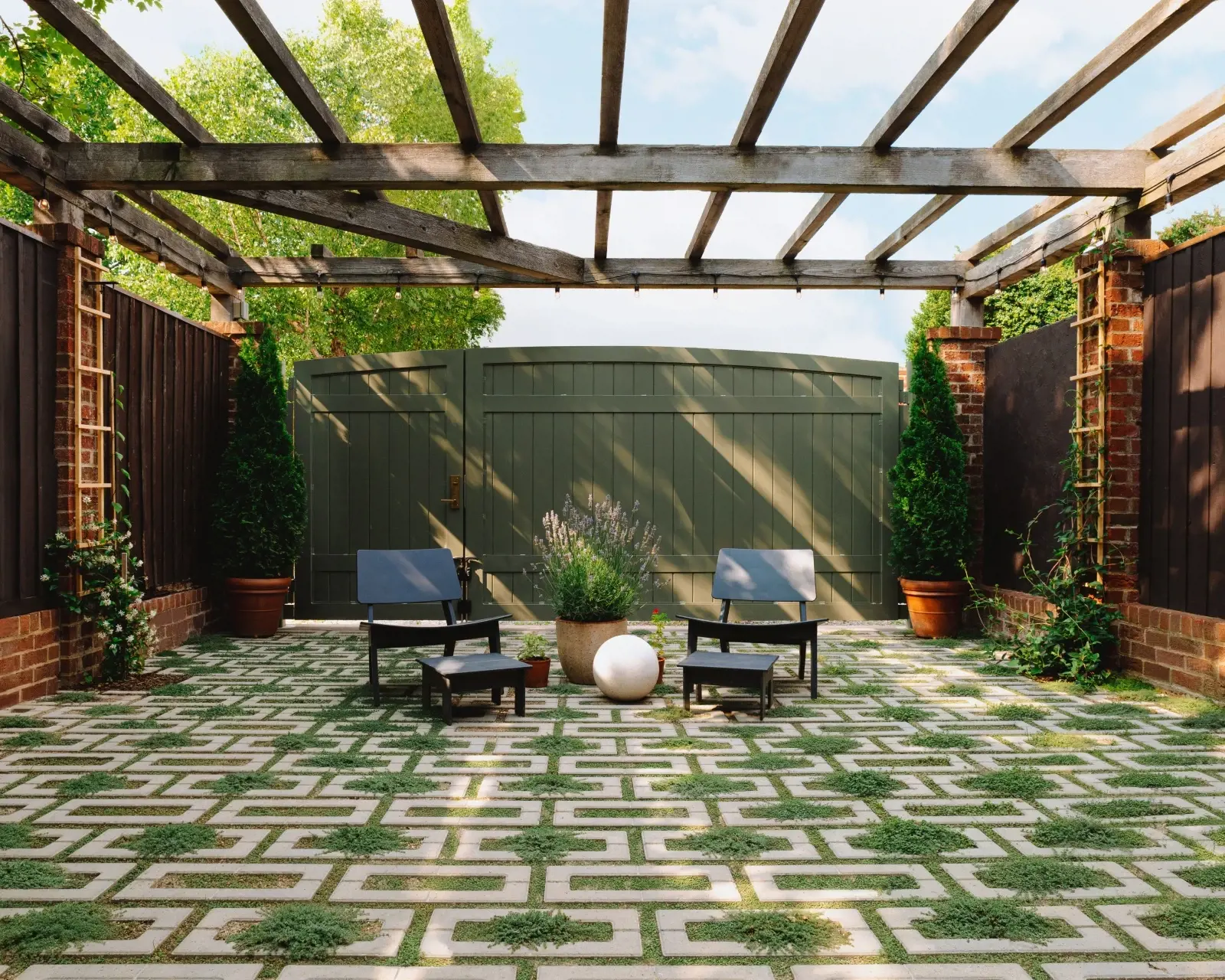 Courtyard designed with permeable Westmount pavers in Merlot, featuring open joints with greenery that allow water to drain naturally while maintaining a refined urban aesthetic.