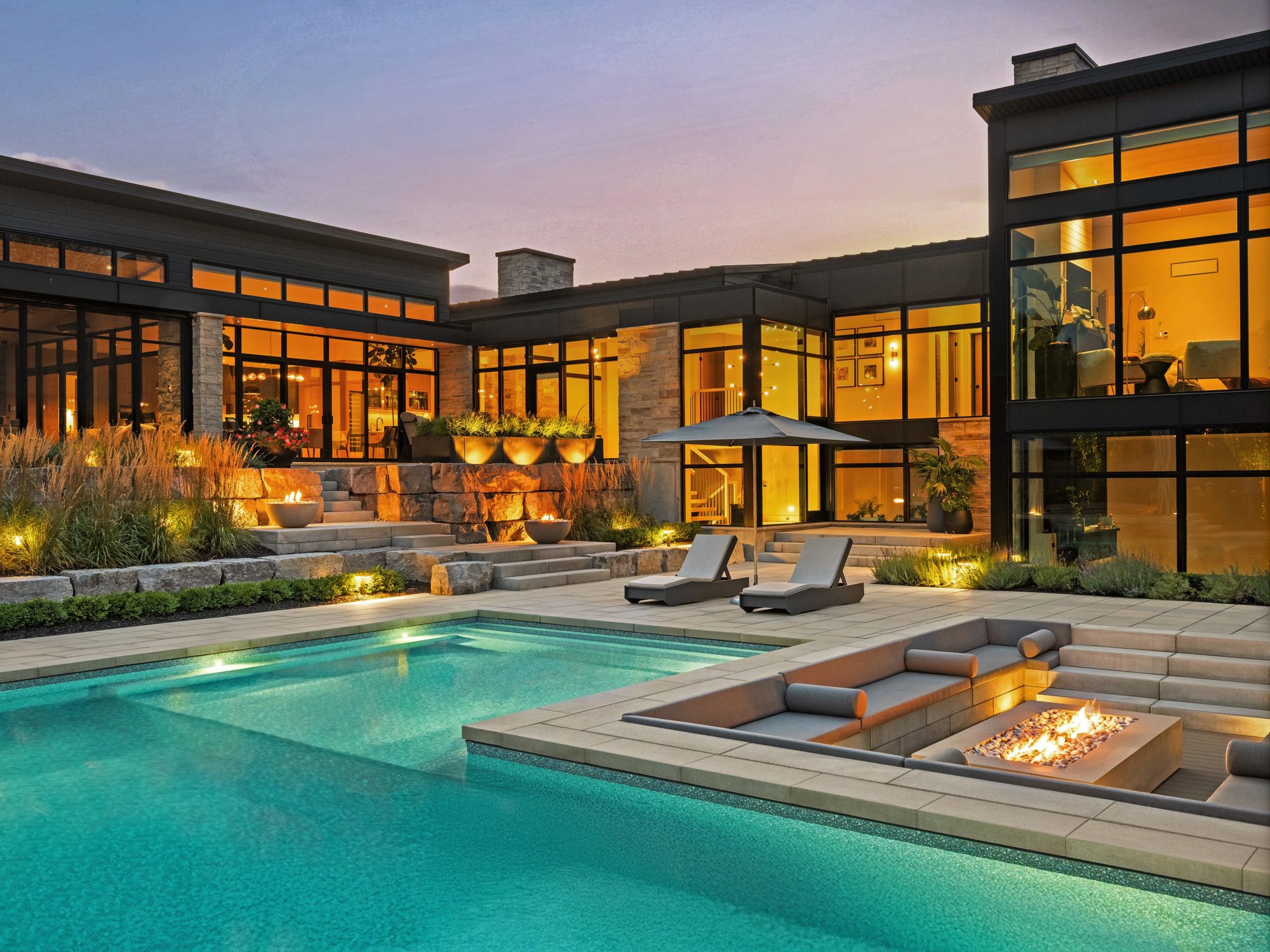 Renovated backyard with tiered terraces built using Blu 60 Slabs in Greyed Nickel, creating multiple functional outdoor zones.