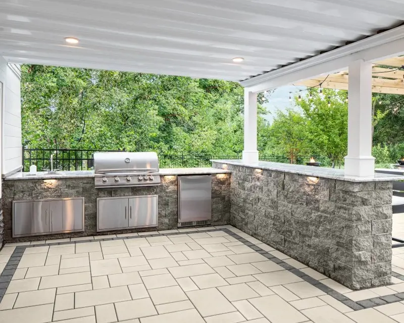 Mini-Creta outdoor kitchen wall in split-stone texture with built-in grill and granite-style counters.