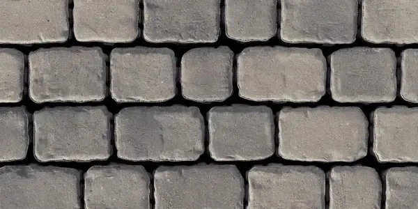 Gros plan sur des pavés Villagio de Techo-Bloc, à texture de pavé arrondie et finition vieillie, offrant un style intemporel d’inspiration européenne dans des tons de gris riches.