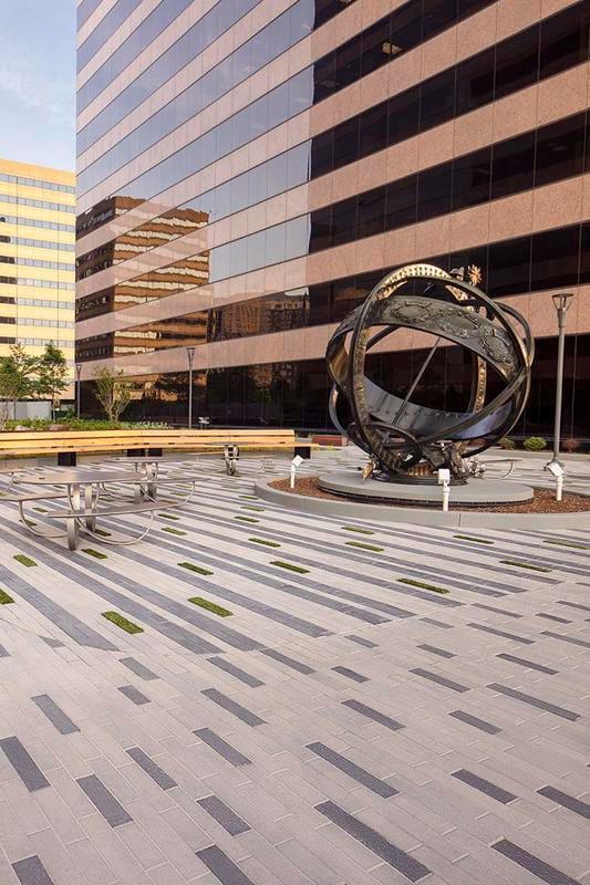 Courtyard featuring Techo-Bloc Linea Paver with a sculpture in the background.