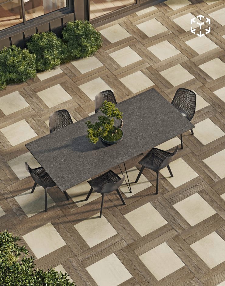 Borealis and Para mosaic layout combining wood-look and smooth pavers in a geometric patio setting with modern outdoor dining.