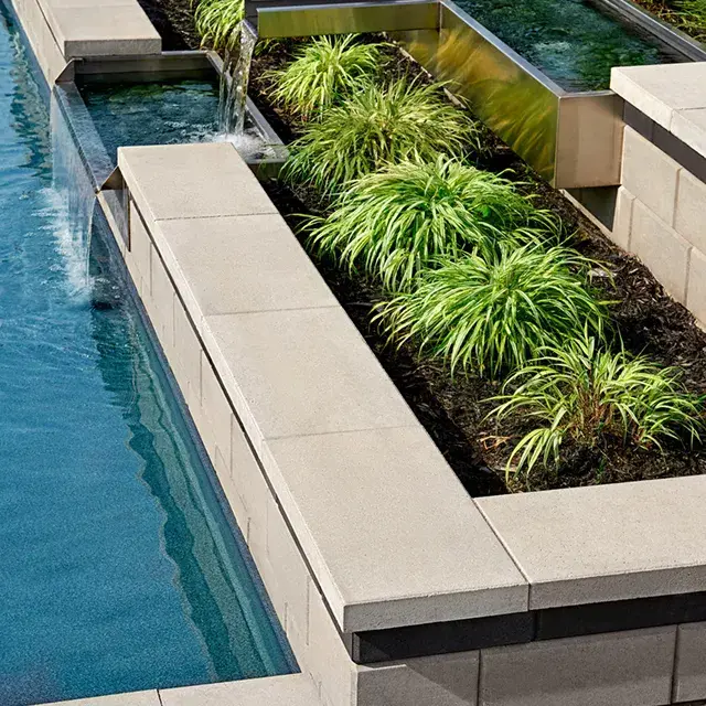 Raffinato Smooth by Techo-Bloc, modern concrete pool cap with sleek edges, providing a refined finish for pool coping and wall tops.