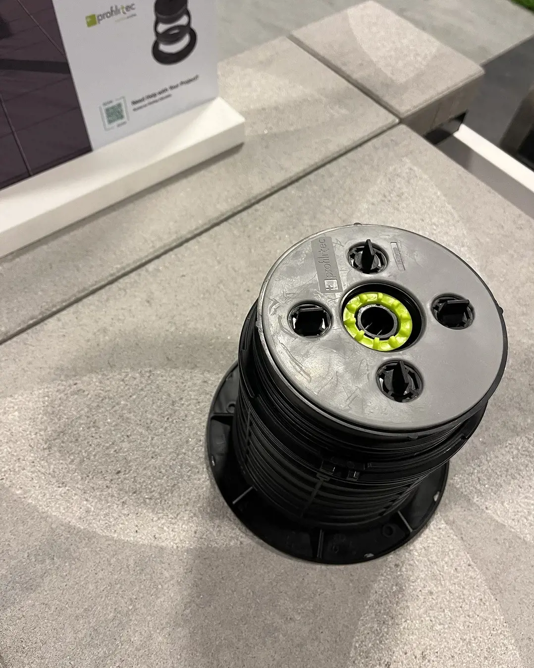 Adjustable pedestal system supporting modern paver installation on an outdoor surface.