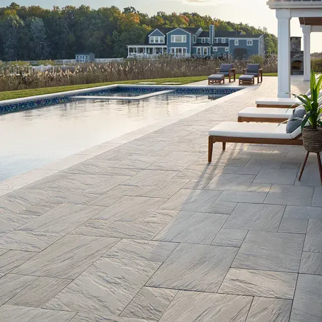 Everest Slabs by Techo-Bloc, with a natural stone look, creating a durable and pedestrian-friendly patio with a smooth surface ideal for outdoor spaces.