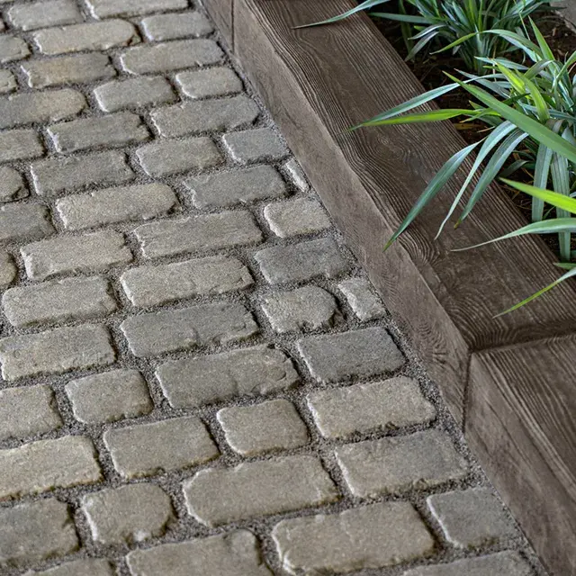 Borealis by Techo-Bloc, wood-like concrete edging stones inspired by railroad ties, perfect for bordering planters, mulch, and garden beds.