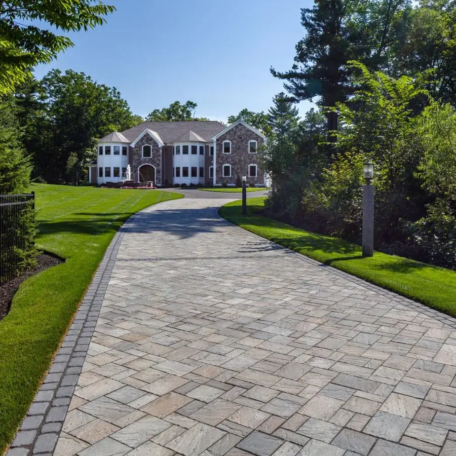 Eva Slate Paver by Techo-Bloc in Champlain Grey with slate texture, forming a cozy patio under a covered outdoor dining area.