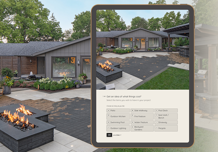 Backyard patio design with concrete pavers and fire pit displayed on a tablet, representing an outdoor project budget estimation tool.