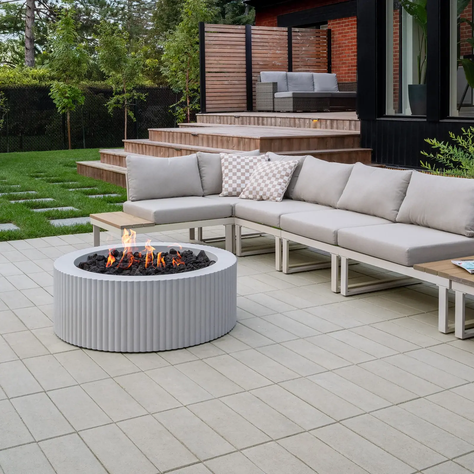 Sculptura Scalloped Firepit in Cool Grey Smooth, isolated product view with flames and lava rocks