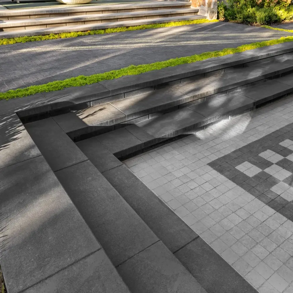 Tiered garden steps finished with Raffinato concrete caps in Onyx Black, creating clean lines and defined edges.