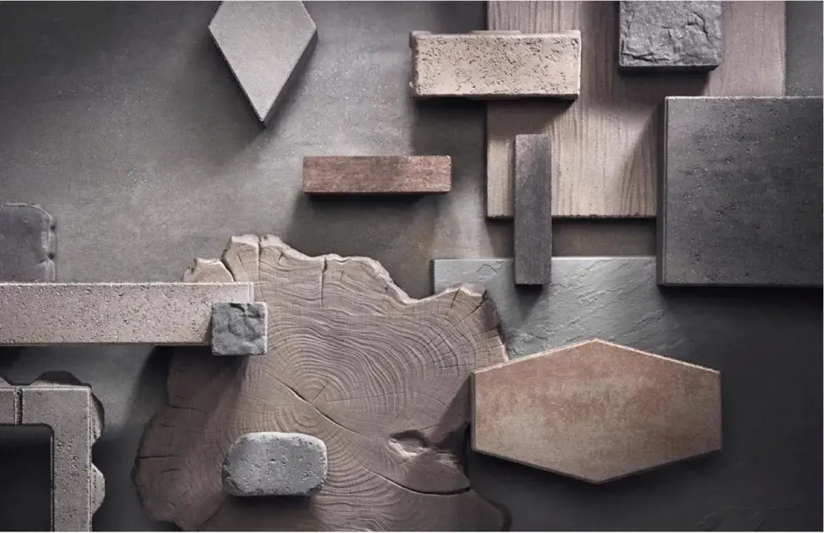 Assortment of Techo-Bloc material samples in various shapes, colors, and textures arranged on a flat surface.