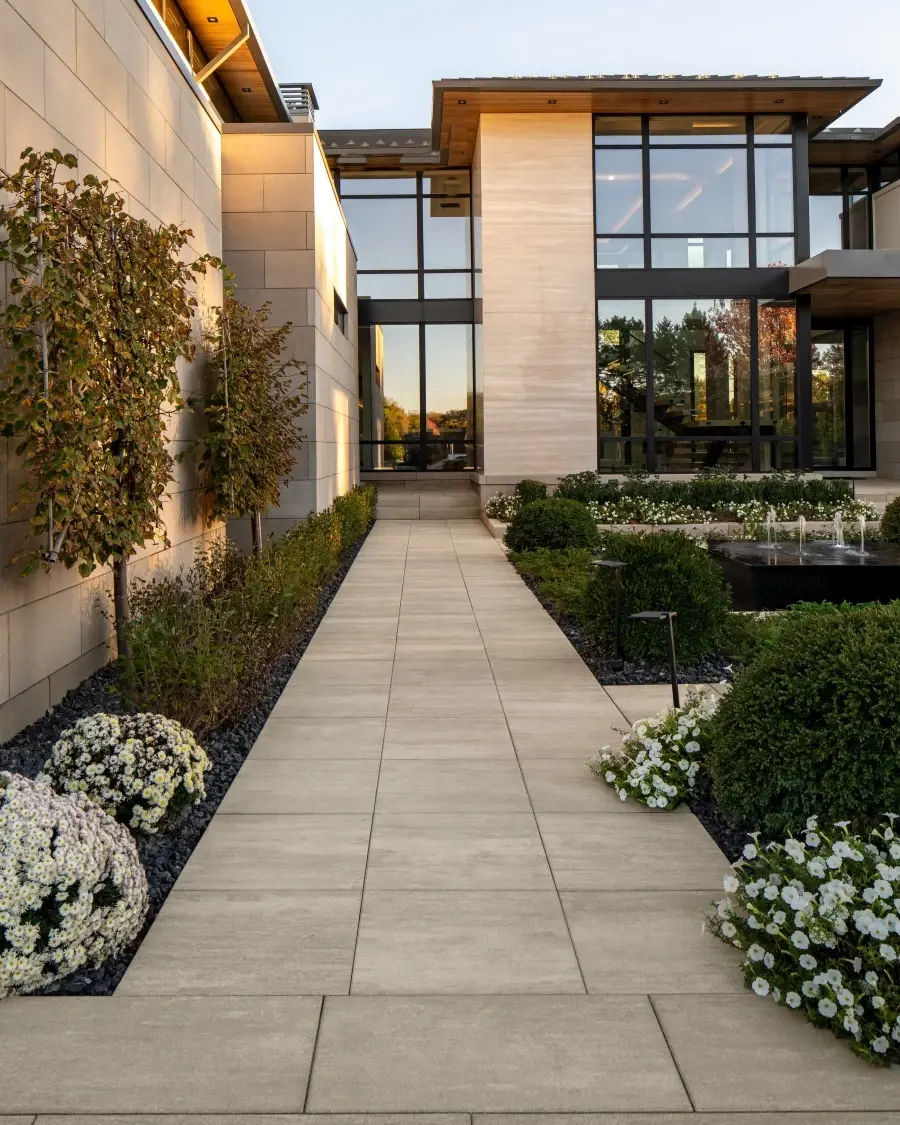 Entry walkway finished with Industria Smooth Slabs in Caffè Crema, creating a welcoming transition that enhances architectural depth and warmth.