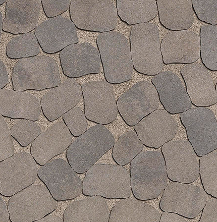 Gros plan du pavé Antika de Techo-Bloc, formes irrégulières et texture vieillie aux teintes naturelles.