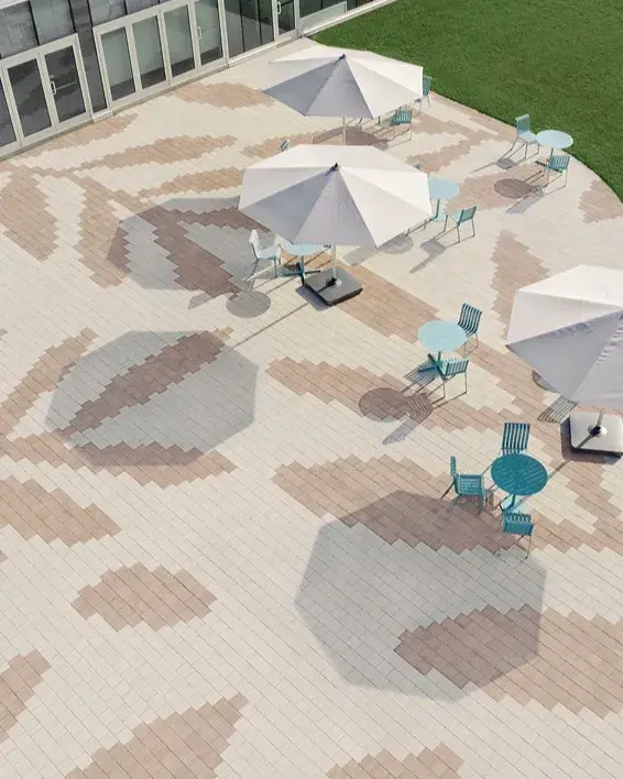 Pavés Industria HD² Granitex en tons beige et brun créant un grand motif floral au centre communautaire de Québec.