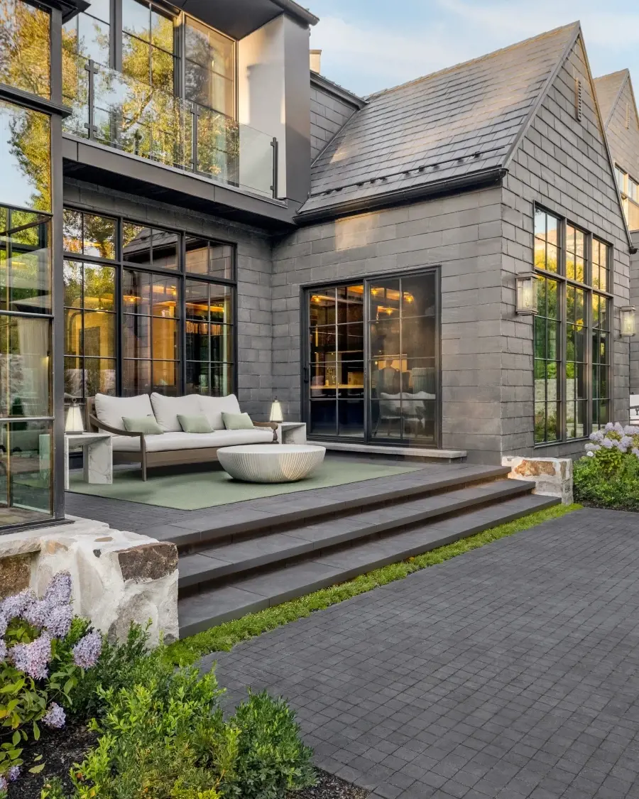 Outdoor living space featuring stone-clad walls, elevated steps, and warm material tones that create intimacy and visual richness.