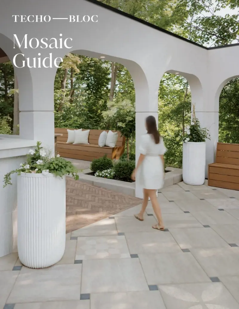 Mosaic Guide by Techo-Bloc featuring a geometric patio design with white planters and architectural archway.