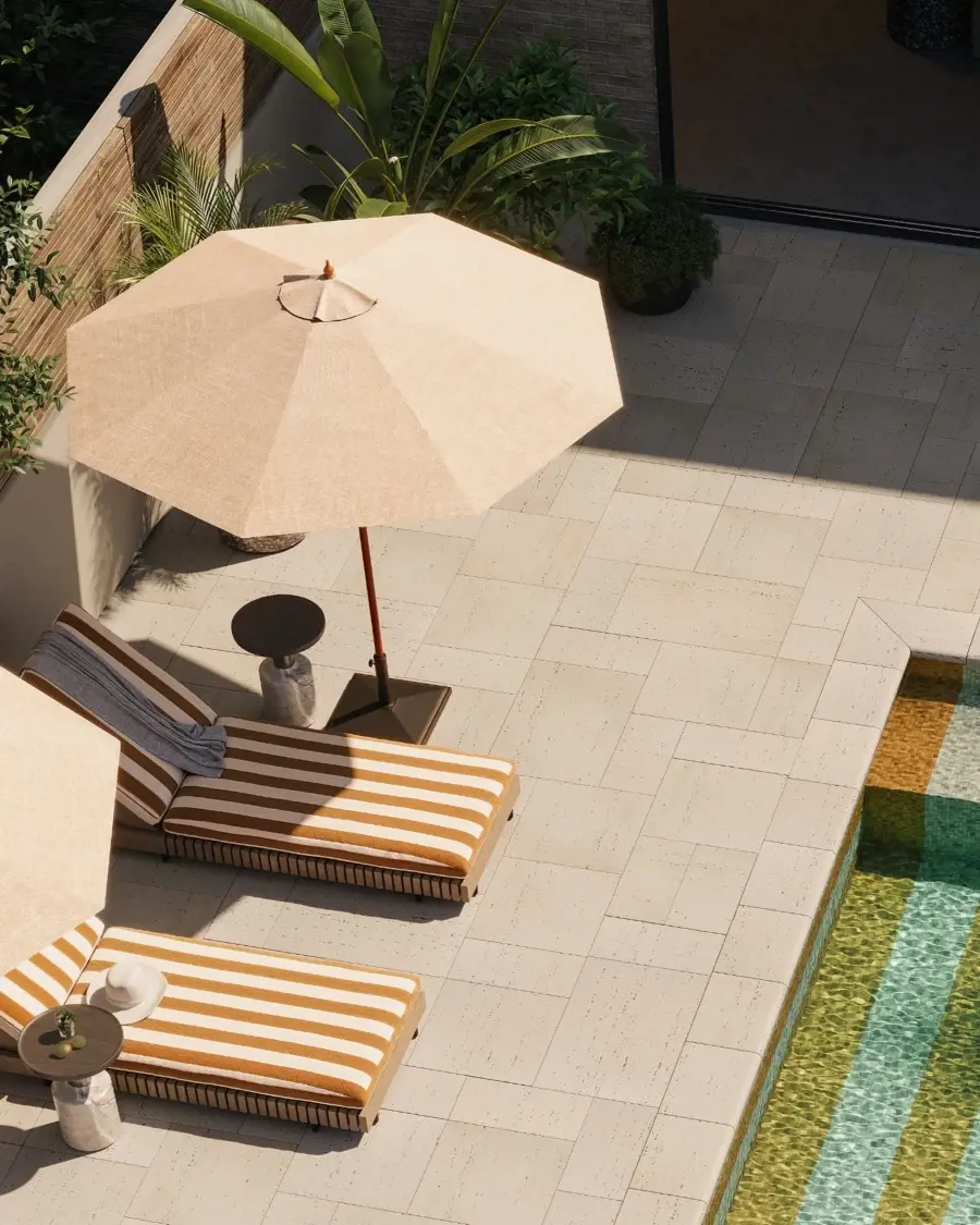 Sunlit patio featuring light natural stone paving, warm textures, and subtle graphic patterns that add character without overpowering the space.
