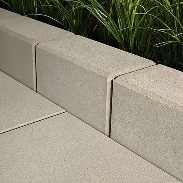 Raffinato Polished by Techo-Bloc, polished concrete edging stones showcasing fine colored aggregates, adding a refined touch to landscaping projects.