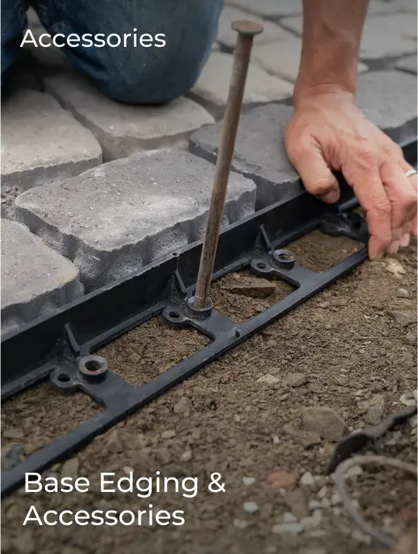 Edge restraint being secured alongside interlocking pavers during installation.